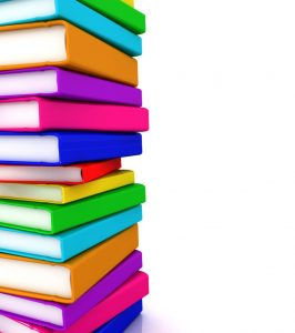 Stack of colorful books against a white background, representing education and knowledge.